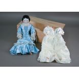 A Victorian china-headed girl doll, on stuffed fabric body with china lower limbs (one leg