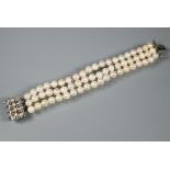 A pearl bracelet, the three-rows of cultured pearls knotted throughout onto fancy white metal set