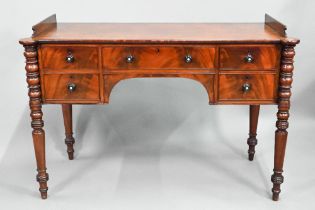 A Victorian kneehole five drawer sideboard, the top with raised gallery sides (back missing) and