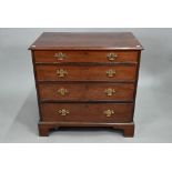 A George III mahogany chest of four long graduated drawers, later brass fittings, raised on shaped