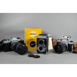 A boxed Halina AI twin lens reflex camera, to/w two Asahi Pentax K1000 slr cameras with Tokina S2-