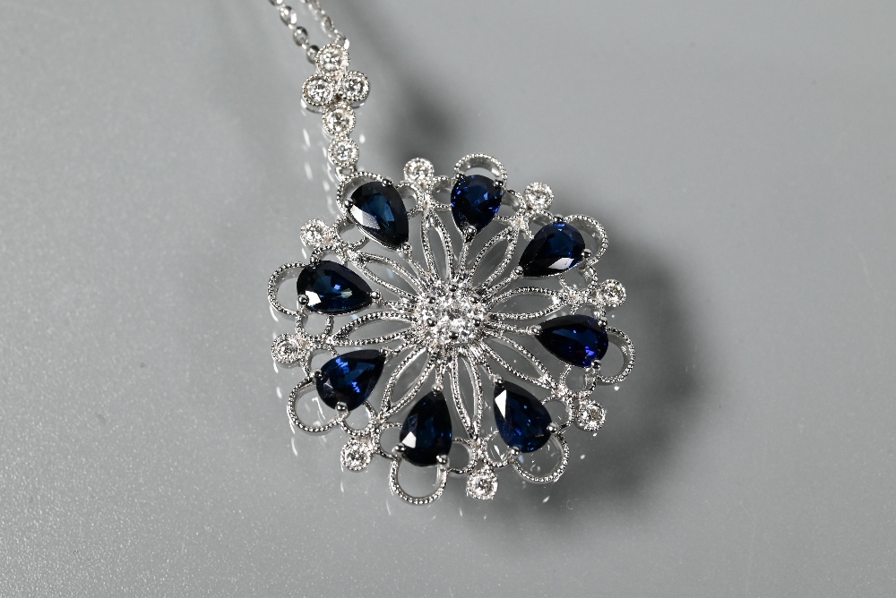 A sapphire and diamond pendant, the open circular millgrain wirework flower-style mount set with - Image 2 of 5