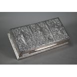 A Siamese Sterling cigarette box, the hinged cover embossed and chased with deities, 21cm wide