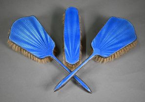 An unmarked blue enamelled three-piece brush set