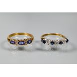 An 18ct yellow gold ring set with three oval blue sapphires with two diamonds between, size P to/w a