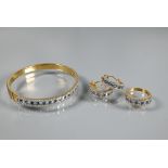 A diamond and blue topaz suite comprising half-hinged bangle with alternate channel-set diamonds and