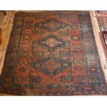 An antique Caucasian Sumak / Soumak carpet, the brown-red ground with geometric guls within wide