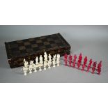 A Chinese lacquer folding chessboard/backgammon board to/w a set of bone chessmen