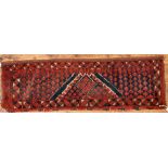 An antique Afghan Turkoman red ground geometric design bag face, 144 cm x 47 cm