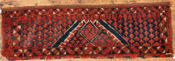 An antique Afghan Turkoman red ground geometric design bag face, 144 cm x 47 cm