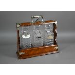 An old silver plate mounted oak three bottle tantalus, 36 cm x 13 cm x 35 cm h (with key)