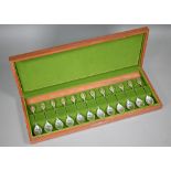 A teak-cased set of twelve Royal Horticultural society Flower Spoons, the finials with inset gilt