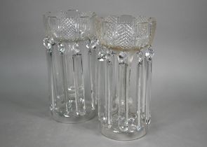 A large pair of cut glass vases, hung with facetted beads and lustres, on hollow knop stems with