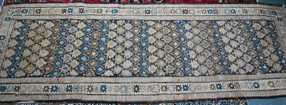 A large old Caucasian kelim, the interlinked design in muted tones on camel ground, 418 cm x 142 cm