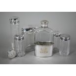 Three cut glass silver-topped toilet jars and a spare lid, London 1892, engraved with initials and