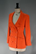 A Chanel Boutique fitted long-line jacket in orange boucle wool, double breasted with four pockets