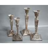 Two pairs of Adam revival loaded silver candlesticks