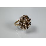 A cocktail ring, circa 1970s, the high domed setting with sapphires and cabochon brown moonstones,