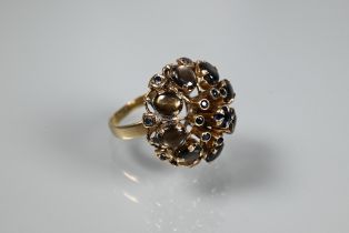 A cocktail ring, circa 1970s, the high domed setting with sapphires and cabochon brown moonstones,