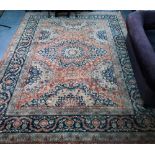 An Indo-Persian Tabriz carpet, the blue/coral ground centred by a floral medallion