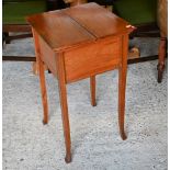 An Edwardian satinwood work table with butterfly-opening top, enclosing a silk lined interior with