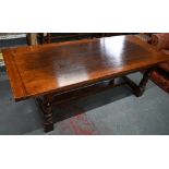 A substantial 17th century style oak refectory table, by Belvedere, Ipswich, the cleated end top