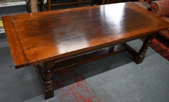 A substantial 17th century style oak refectory table, by Belvedere, Ipswich, the cleated end top