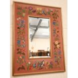 A rectangular bevelled wall mirror in flora and fauna tapestry frame, 60 cm wide x 78 cm high