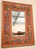 A rectangular bevelled wall mirror in flora and fauna tapestry frame, 60 cm wide x 78 cm high