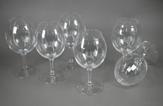 A set of six large and good quality wine-glasses, etched with gryphon crests, on octagonal-cut