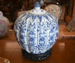 A Chinese blue and white porcelain melon-shaped jar and cover, on carved wood stand, 24 cm diam