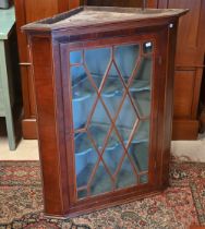 A George III mahogany lattice glazed hanging corner cupboard, 76 cm w x 95 cm h