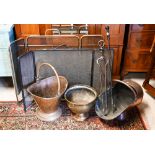 An antique copper coal scuttle to/with a brass coal bucket, a brass planter, two (differing) fire