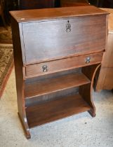 An Arts & Crafts period slope front bureau, over a drawer and two open shelves, 75 cm w x 31 cm x