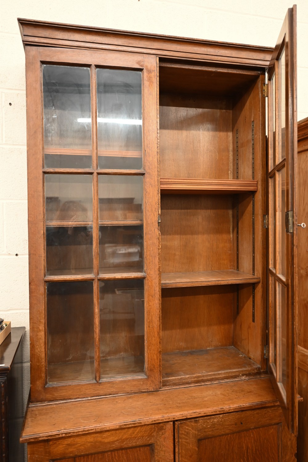 An early 20th century oak cabinet bookcase, the top section with glazed doors enclosing adjustable - Image 3 of 5