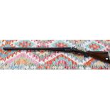An antique 12 bore double-barrelled shotgun with hammer action by George Graham & Sons, Oxford