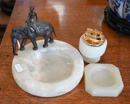 An onyx cufflink bowl surmounted by a bronzed Indian elephant to/w an onyx lighter and ashtray (3)