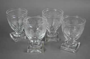 A set of four Regency glass rummers with vine etched decoration on squat stems and heavy square