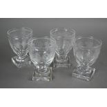 A set of four Regency glass rummers with vine etched decoration on squat stems and heavy square