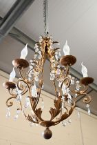 A gilt metal foliate five branch chandelier hung with faceted glass drops