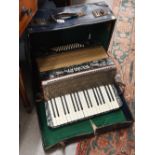 A cased Alvari accordion with marbled body