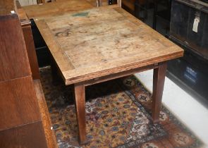 An old oak draw leaf dining table, raised on square legs