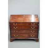 A George III mahogany bureau, the well fitted interior with leather faux book spine 'secret' storage