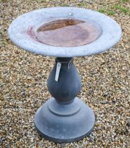 A modernist cast stone bird bath