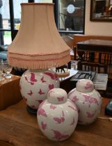 Three Asian globular jars and covers painted with pink butterflies (one converted as a lamp)