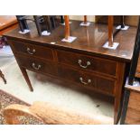 An Edwardian cross-banded walnut three drawer sideboard, raised on square tapering legs on brass