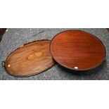 An antique mahogany lazy Susan, 54 cm dia. x 15 cm h to/with an oval brass handles tray - both a/