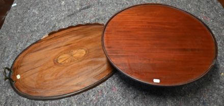 An antique mahogany lazy Susan, 54 cm dia. x 15 cm h to/with an oval brass handles tray - both a/