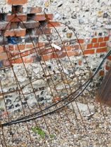 A pair of weathered steel arrowhead obelisks (2)