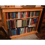A stained pine open bookcase with two shelves, 126 cm wide x 24 cm z 106 cm high